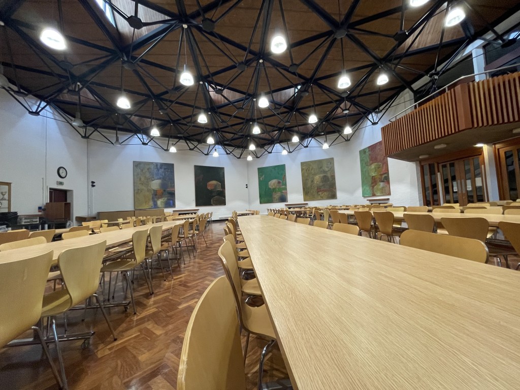 An image of Trevs dining hall, from the high table. You can view all of the tables with no one sat in them.