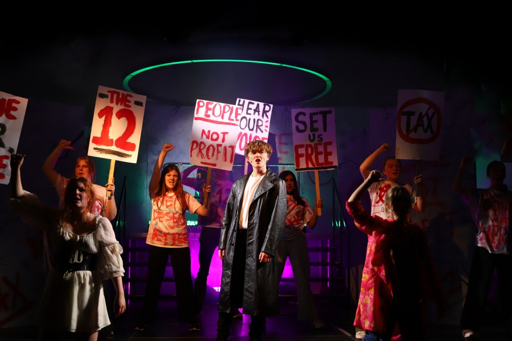 Harry Threapleton as Jesus surrounded by his followers, who are protesting for change. 