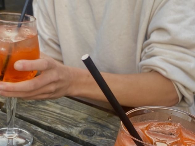 There aperol spritz drinks on an outdoor table