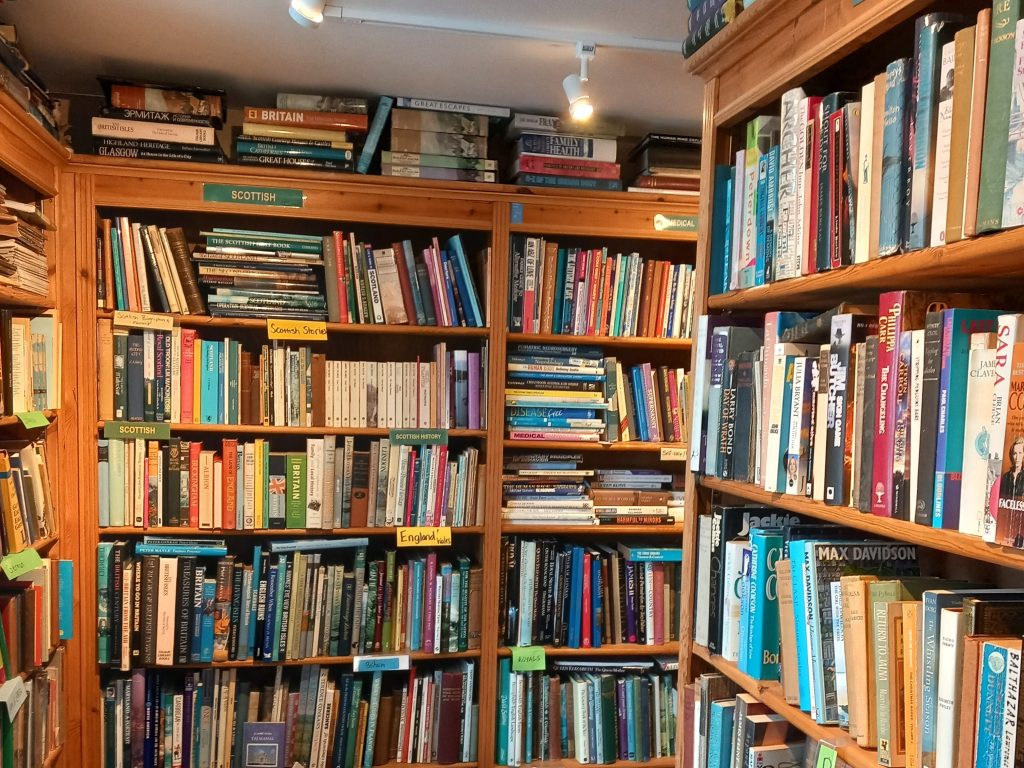 A photo of numerous shelves adorned with lots of books.