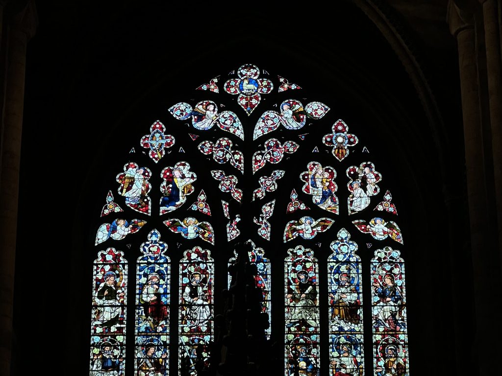 An image of the stained glass windows of a church